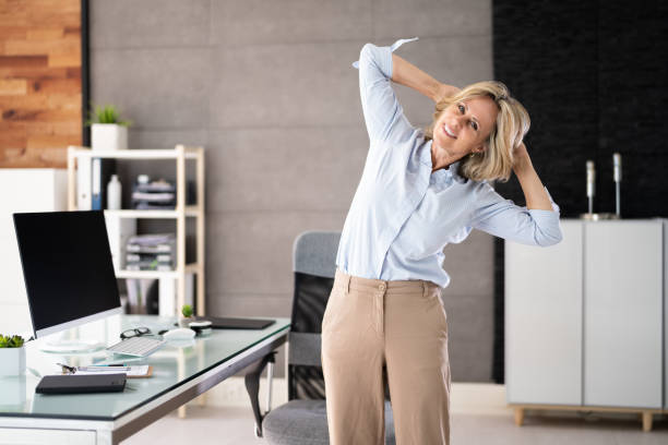 Person performing seated shoulder stretch at desk